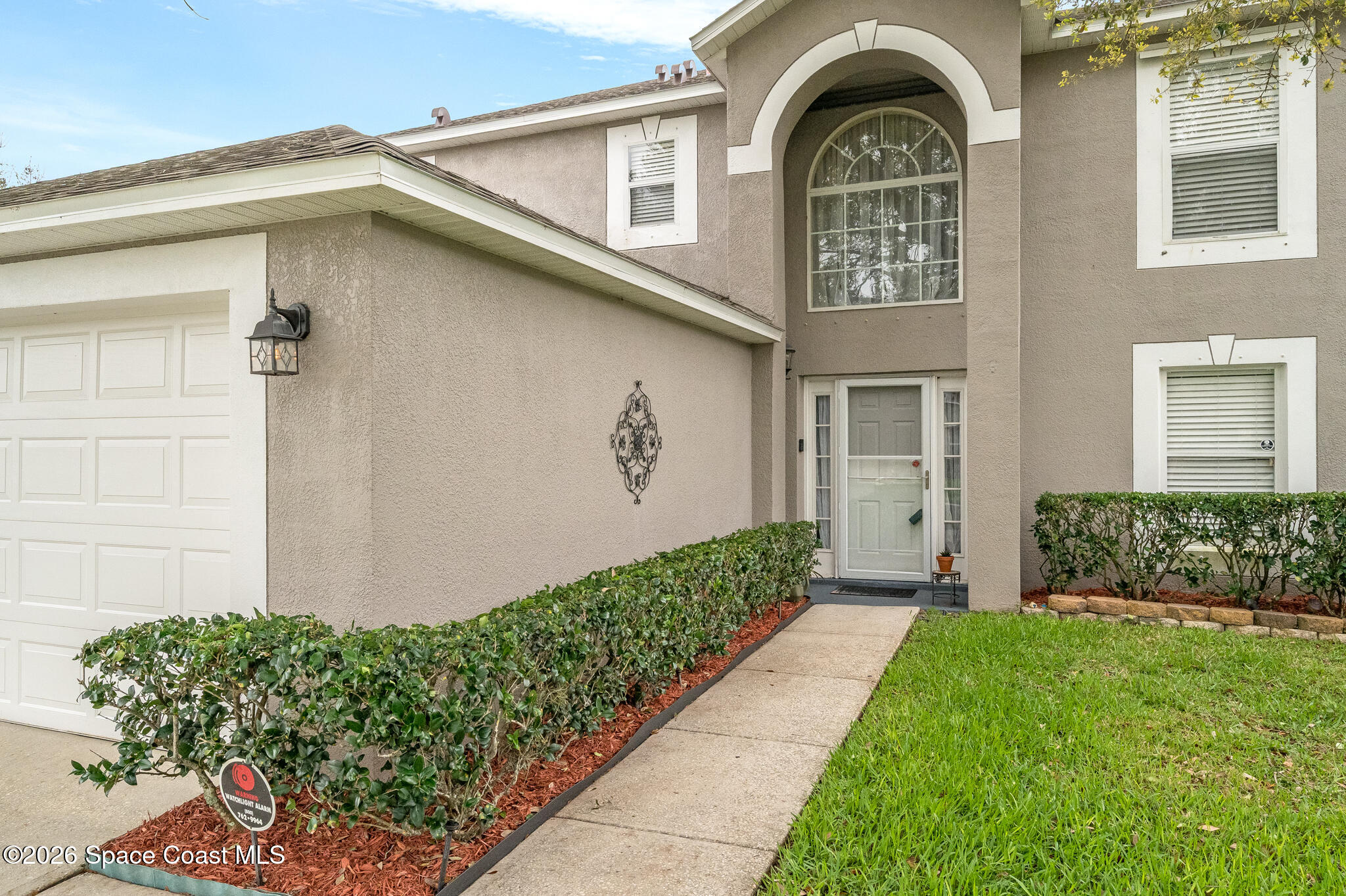 2250 Spring Creek Circle Palm Bay, FL 32905 - Photo 6 of 84 a front view of a house with garden