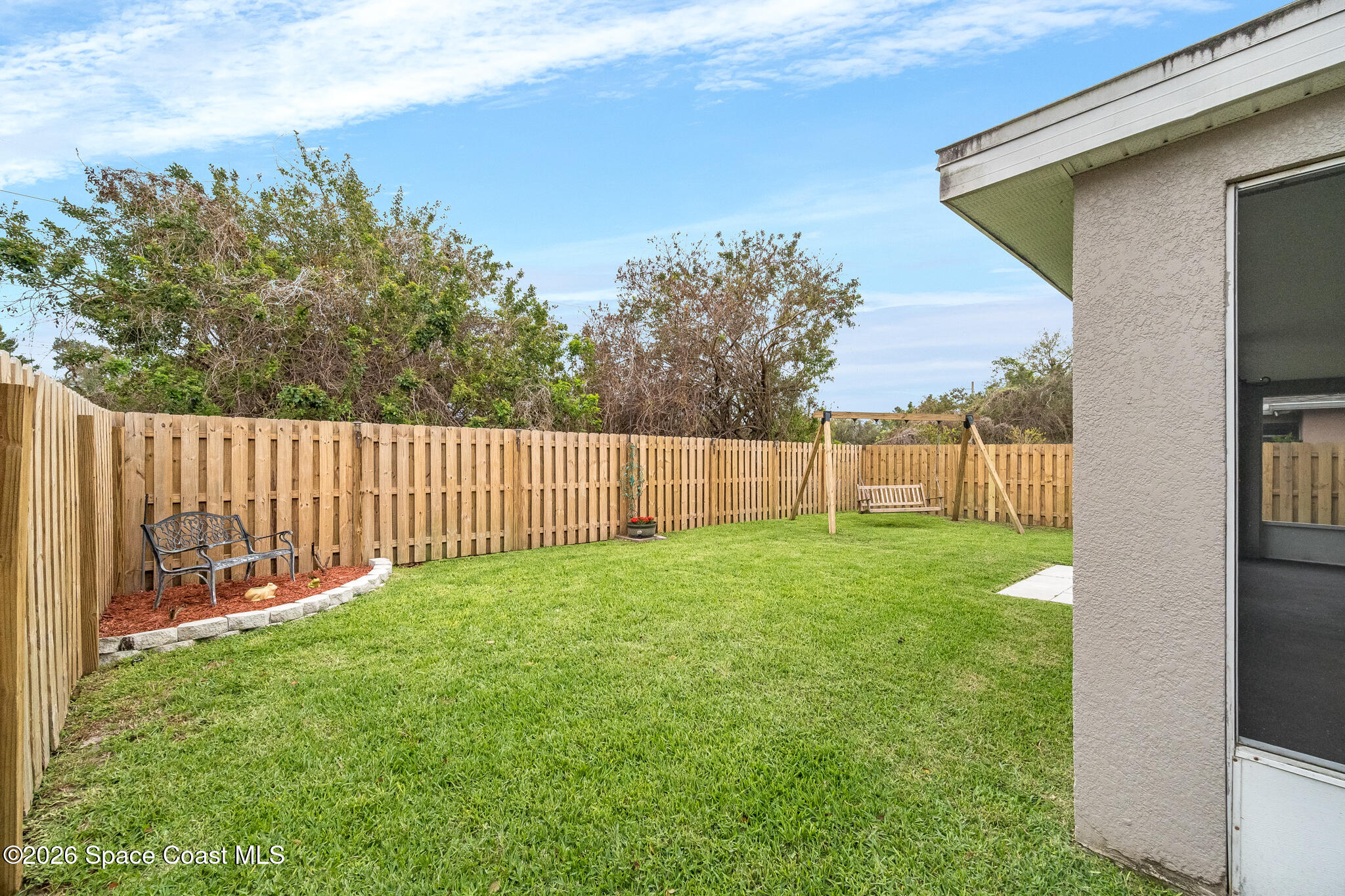 2250 Spring Creek Circle Palm Bay, FL 32905 - Photo 69 of 84 a view of a backyard with a garden