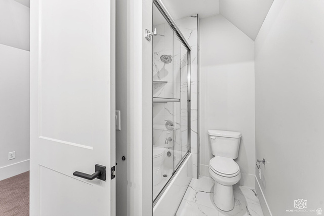 1468 South Red Cliffs Temple Lane St. George, UT 84790 - Photo 48 of 64 Bathroom featuring combined bath / shower with glass door, vaulted ceiling, and light marble finish floors