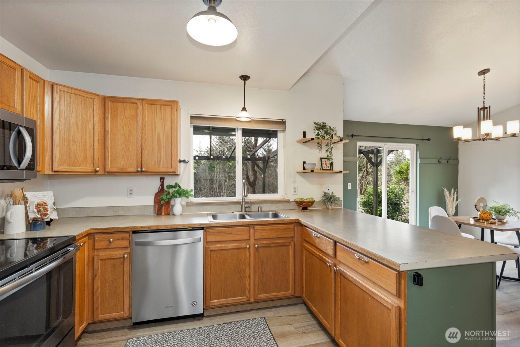 421 Northeast Cutlass Way Belfair, WA 98528 - Photo 11 of 35 a kitchen with a sink stove and cabinets