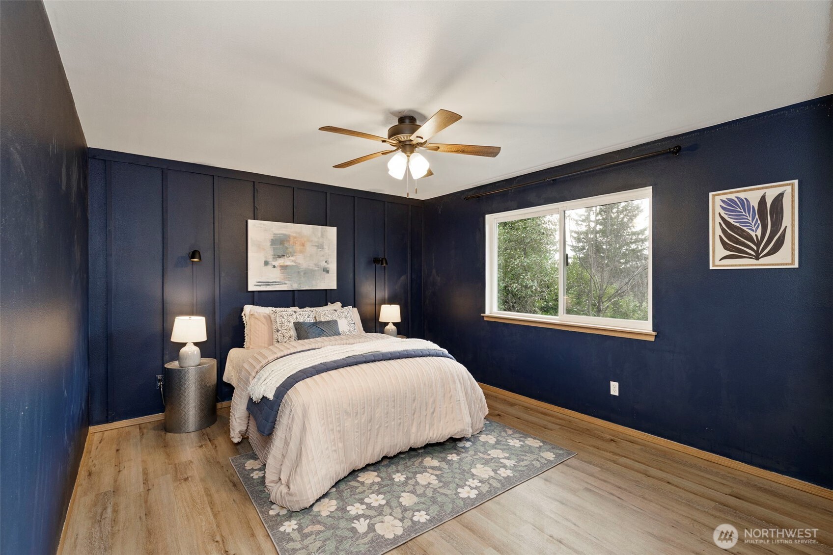 421 Northeast Cutlass Way Belfair, WA 98528 - Photo 14 of 35 a bed room with a bed and a chandelier