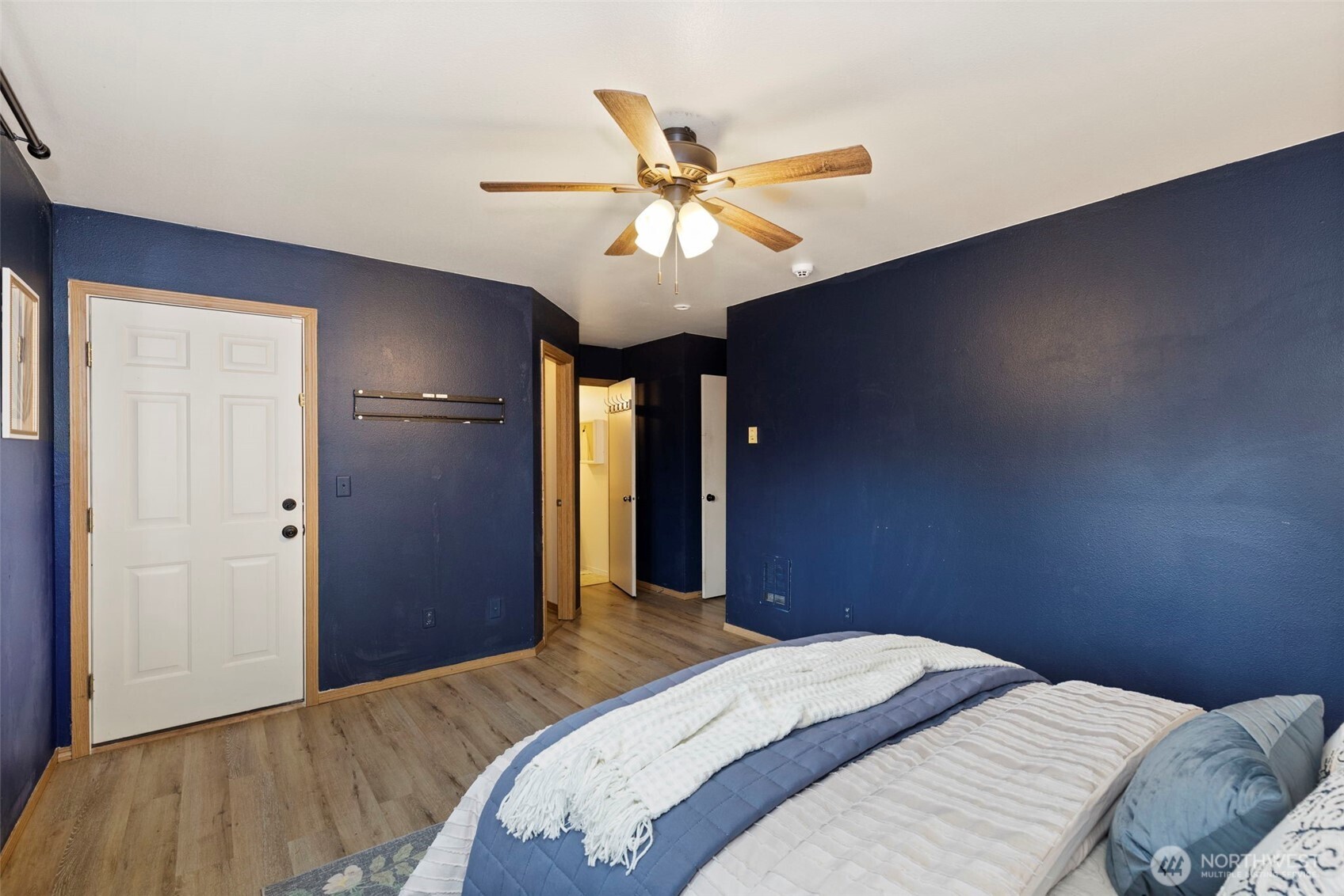 421 Northeast Cutlass Way Belfair, WA 98528 - Photo 15 of 35 a bedroom with a bed and a chandelier