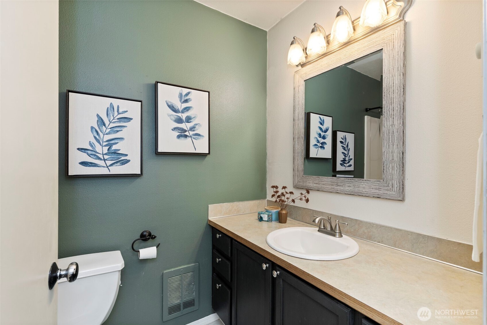421 Northeast Cutlass Way Belfair, WA 98528 - Photo 19 of 35 a bathroom with a toilet sink and mirror