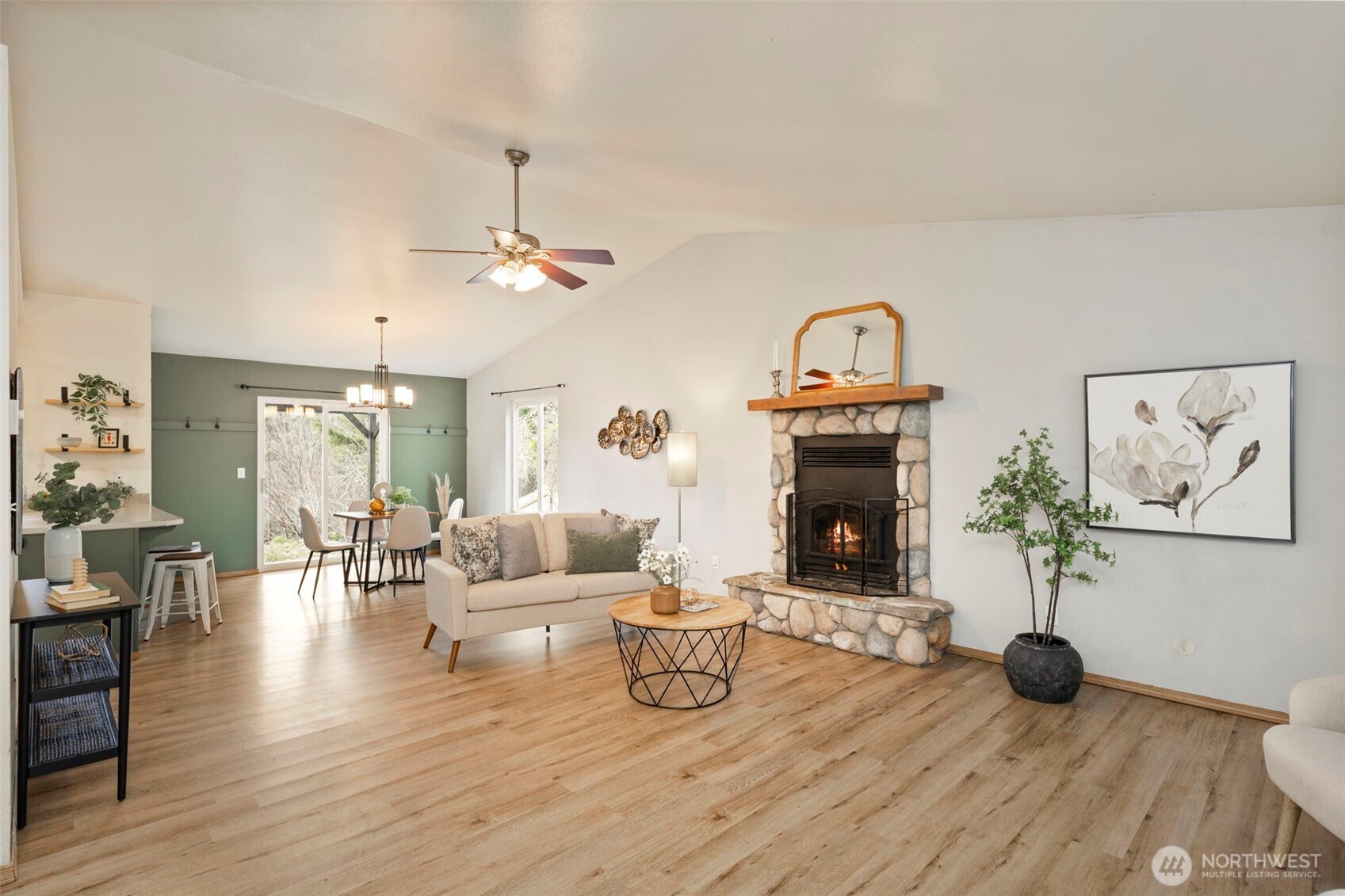 421 Northeast Cutlass Way Belfair, WA 98528 - Photo 6 of 35 a living room with furniture and a fireplace