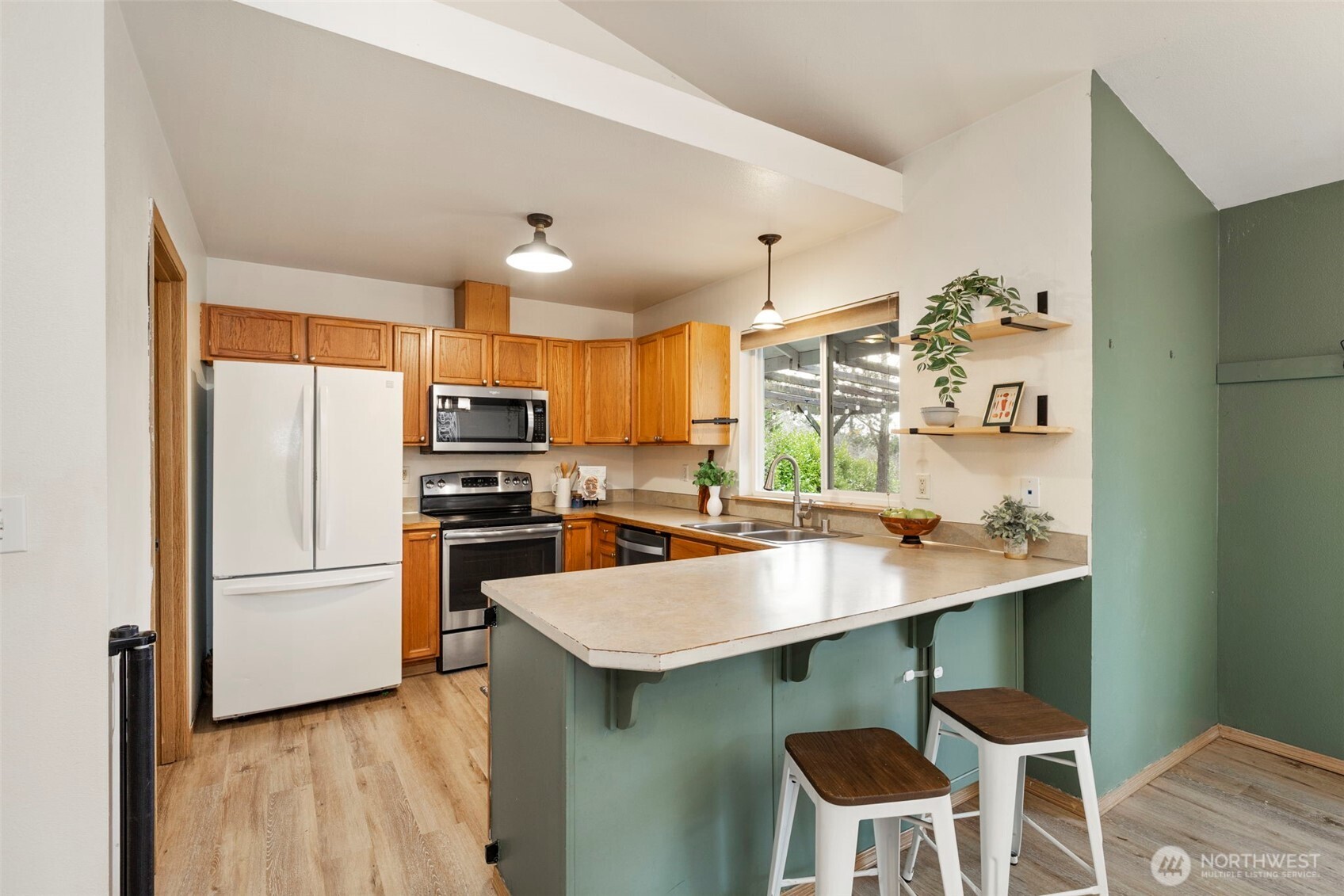 421 Northeast Cutlass Way Belfair, WA 98528 - Photo 10 of 35 a kitchen with cabinets a counter space and stainless steel appliances