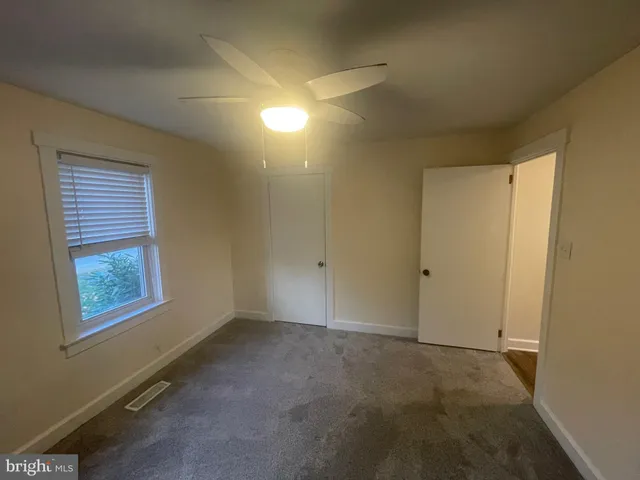 a view of an empty room and a window