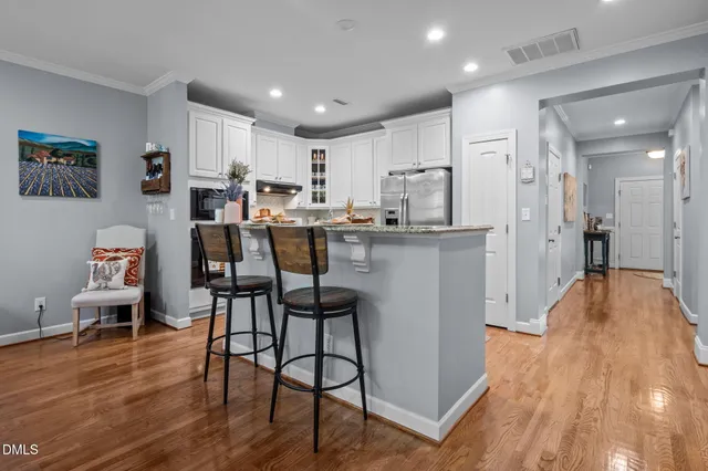 a view of a dining room with furniture and wooden floor