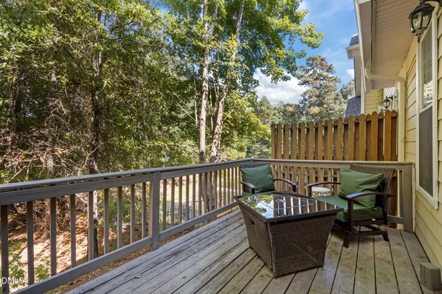 a view of balcony with wooden floor and outdoor seating