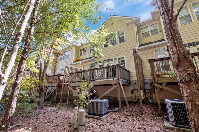 a backyard of a house with barbeque oven and plants