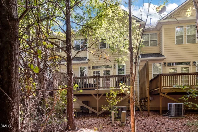 a view of a chair and table in the back yard of the house
