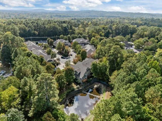 an aerial view of a houses with a yard