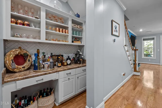 a kitchen with stainless steel appliances granite countertop a refrigerator and wooden floor