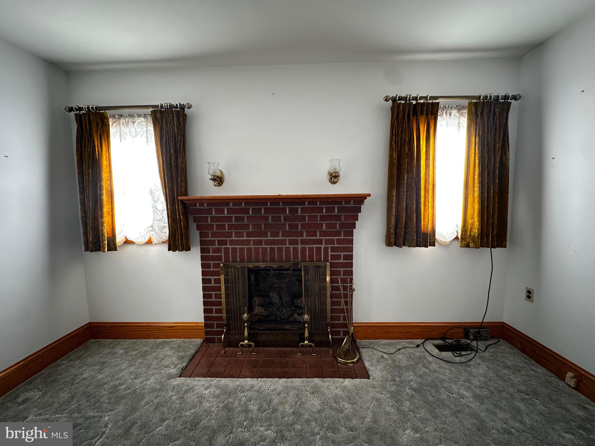 3500 Paw Paw Road Paw Paw, WV 25434 - Photo 23 of 48 a living room with a fireplace and windows