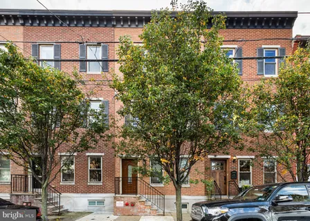 front view of a building with a tree