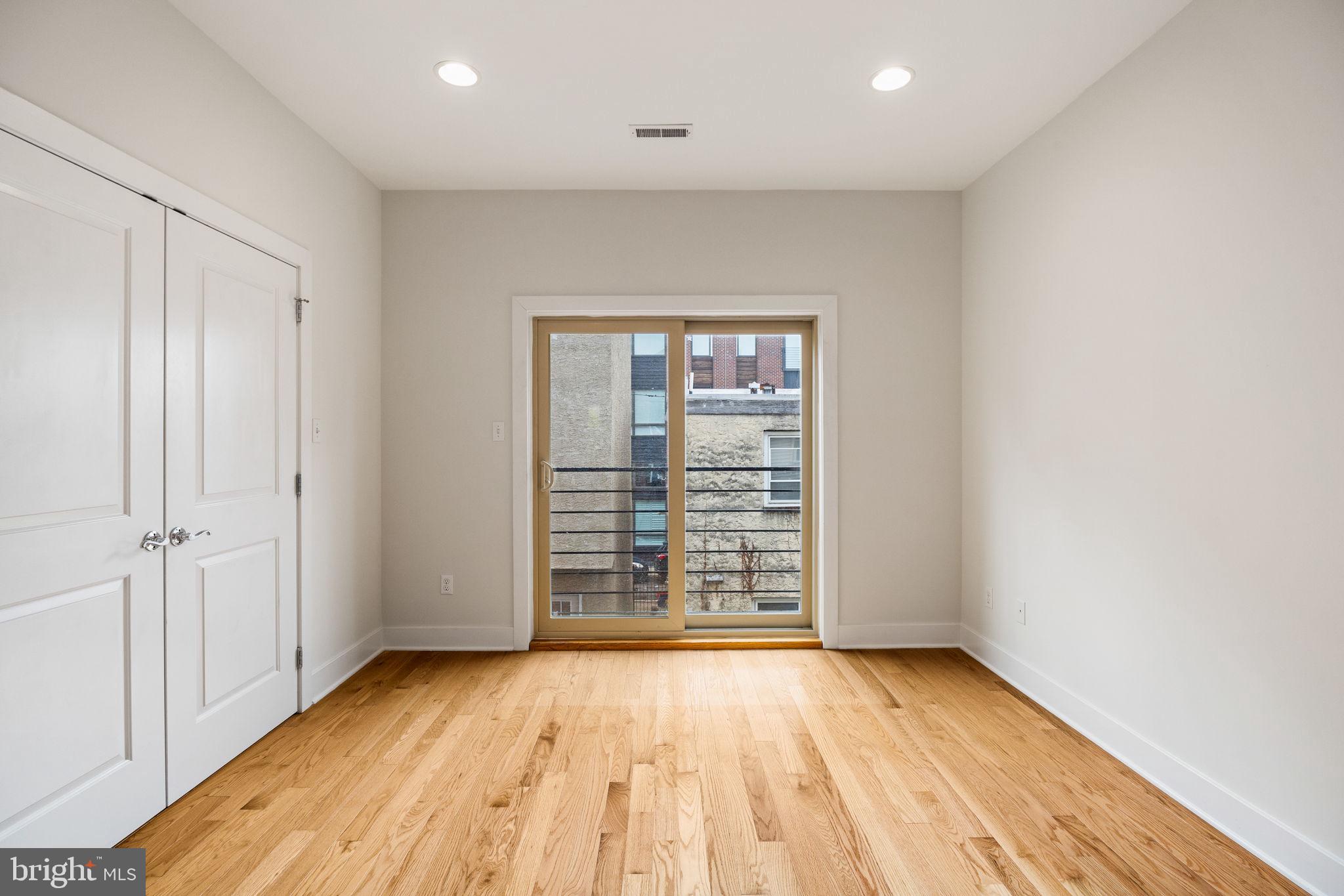 2140 Carpenter Street Philadelphia, PA 19146 - Photo 17 of 41 an empty room with wooden floor and windows