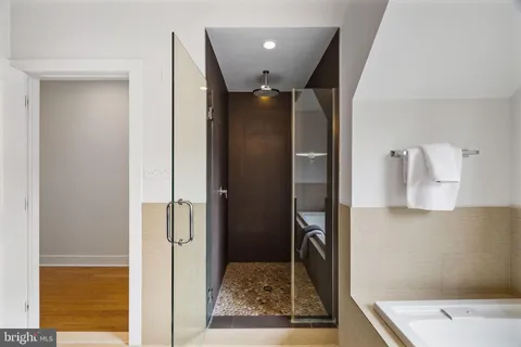 a couple of chairs sitting in a roof deck with a barbeque