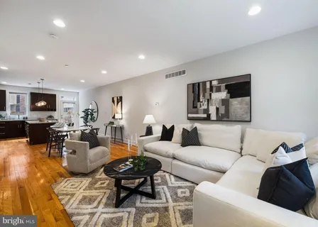 a living room with furniture and a lamp