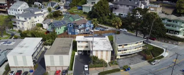 an aerial view of residential houses and outdoor space