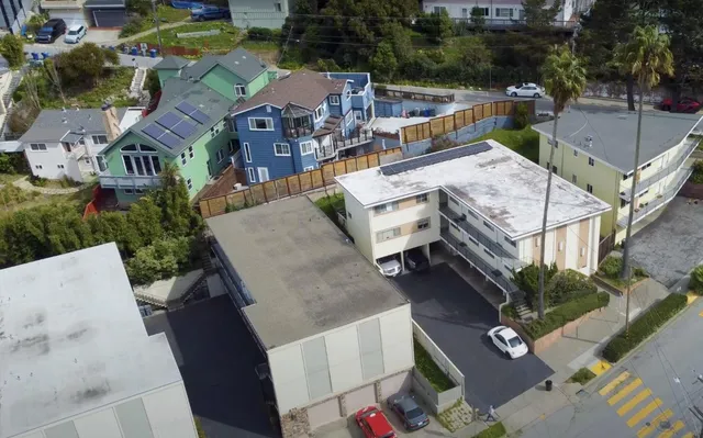 an aerial view of a house with a yard