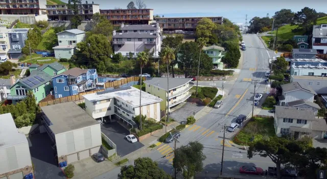 an aerial view of residential houses with outdoor space