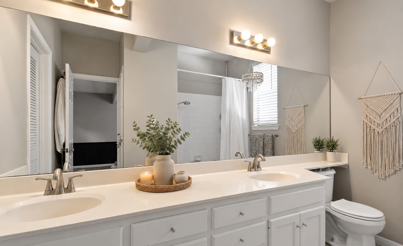 611 East 45th Street, Unit 25 Austin, TX 78751 - Photo 21 of 21 Bathroom featuring a dual vanity with white cabinetry and integrated sinks, brushed nickel faucets, and a full-width mirror