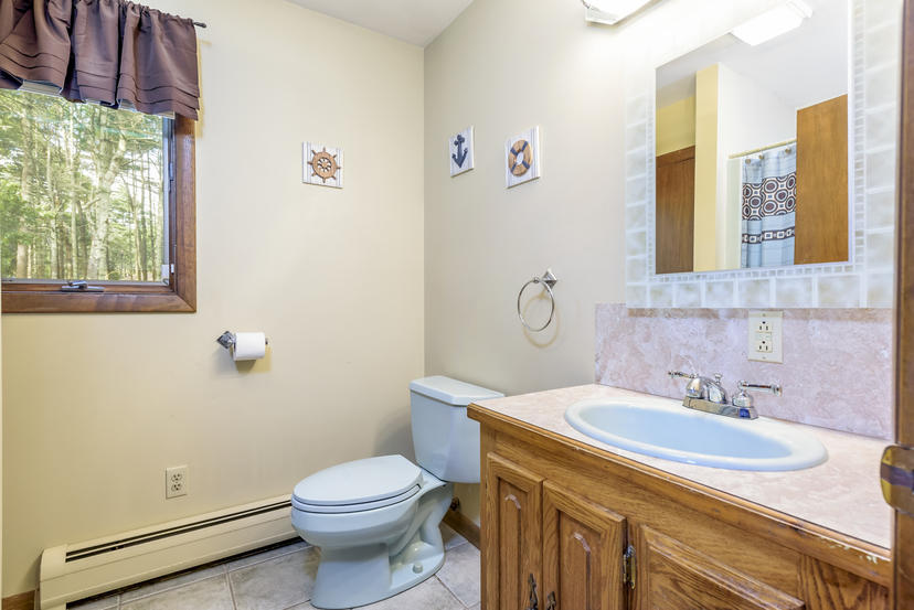 595 Reed Road Dartmouth, MA 02747 - Photo 18 of 25 a bathroom with a sink a toilet and a mirror
