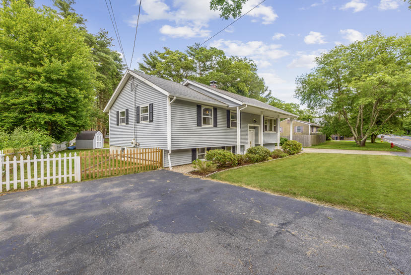 595 Reed Road Dartmouth, MA 02747 - Photo 3 of 25 a view of a house with a yard and fence