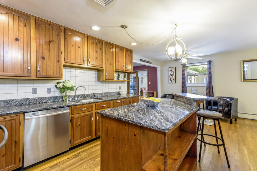 595 Reed Road Dartmouth, MA 02747 - Photo 8 of 25 a kitchen with granite countertop kitchen island stainless steel appliances a sink stove and cabinets