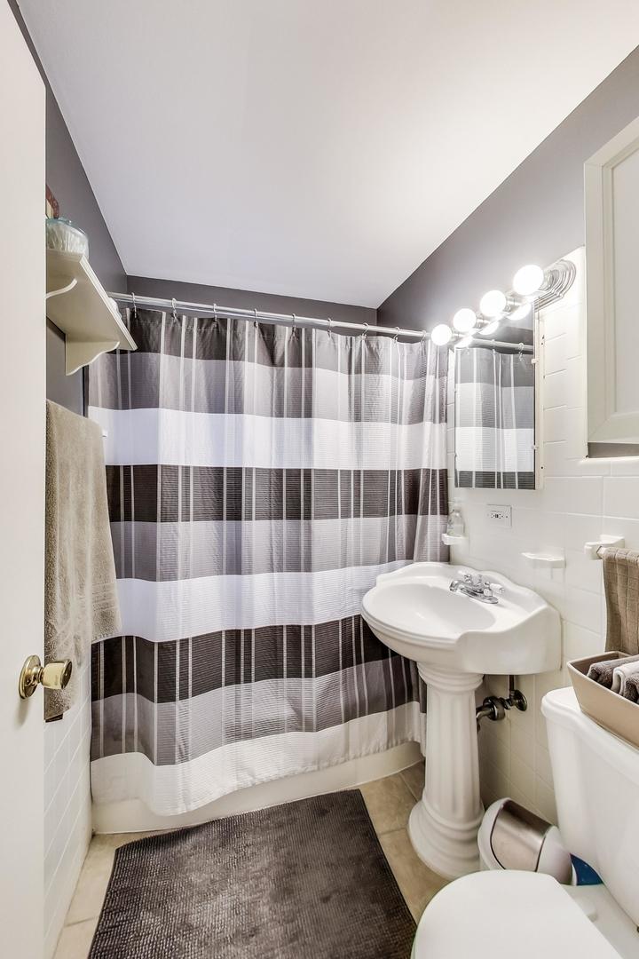 2717 West Rascher Avenue Chicago, IL 60625 - Photo 12 of 37 a bathroom with a sink toilet and shower