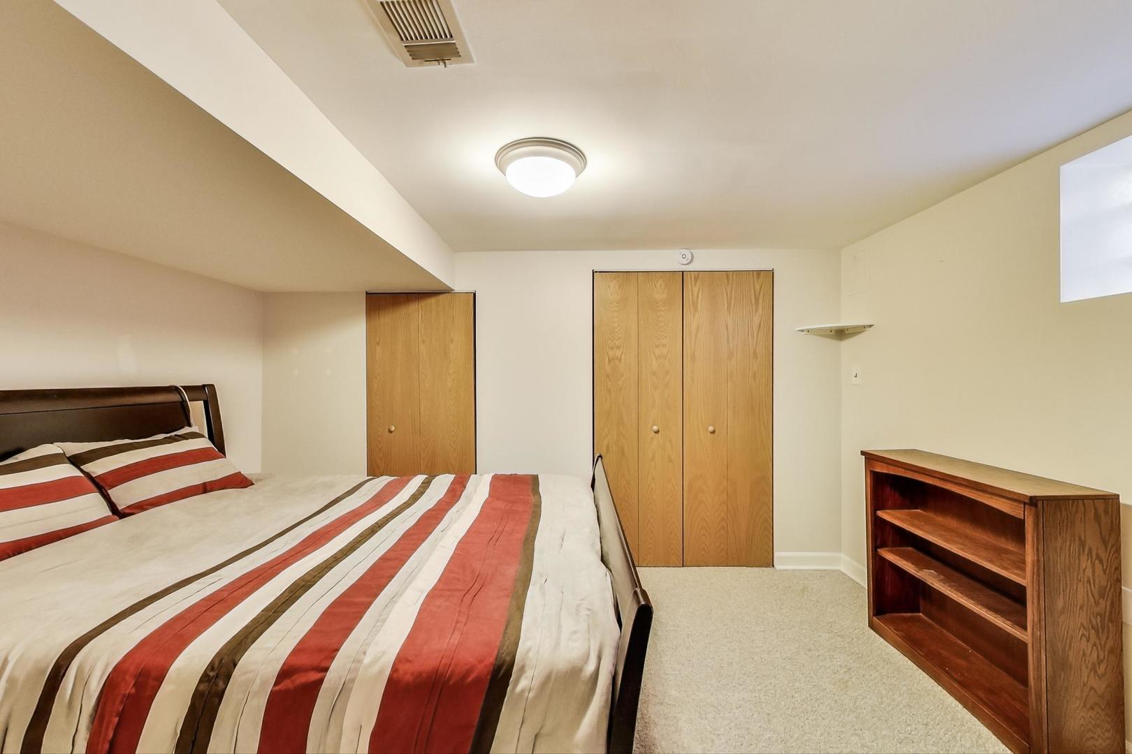 2717 West Rascher Avenue Chicago, IL 60625 - Photo 16 of 37 a bedroom with a bed and a night stand