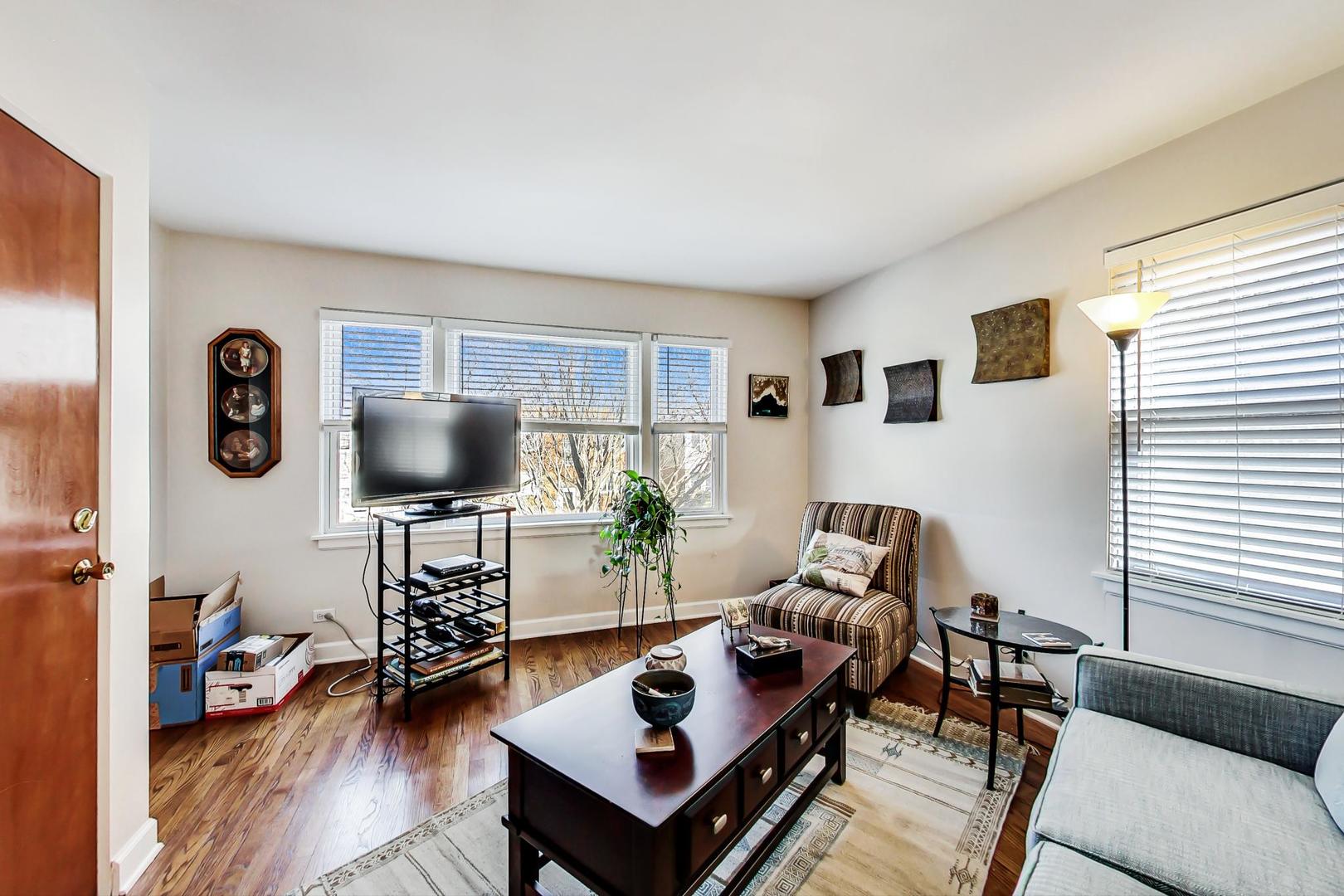 2717 West Rascher Avenue Chicago, IL 60625 - Photo 23 of 37 a living room with furniture and a flat screen tv