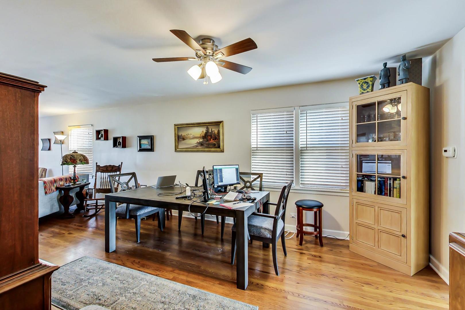 2717 West Rascher Avenue Chicago, IL 60625 - Photo 24 of 37 a dining room with wooden floor and white walls