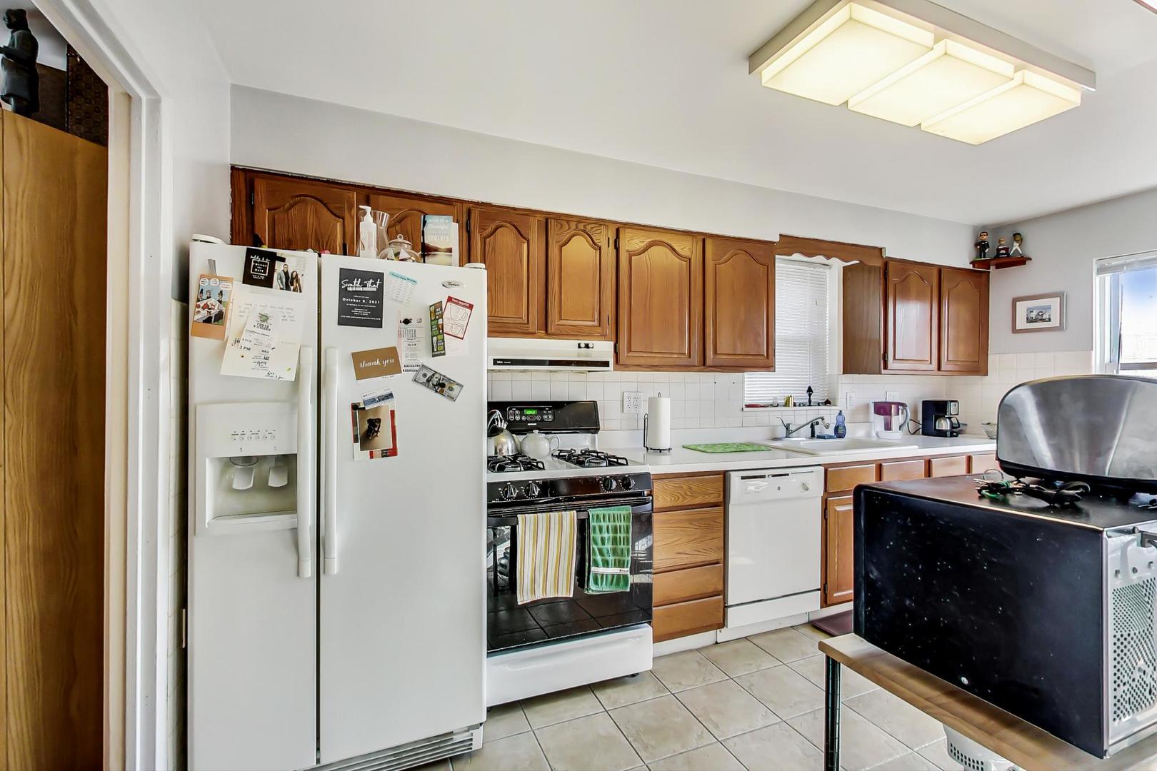 2717 West Rascher Avenue Chicago, IL 60625 - Photo 25 of 37 a kitchen with stainless steel appliances granite countertop a refrigerator and a stove top oven