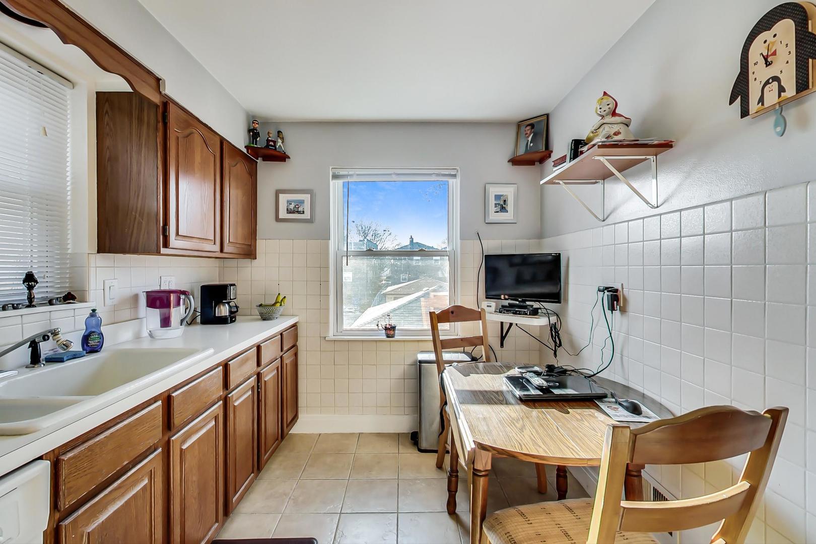 2717 West Rascher Avenue Chicago, IL 60625 - Photo 26 of 37 a kitchen with stainless steel appliances granite countertop a sink and cabinets