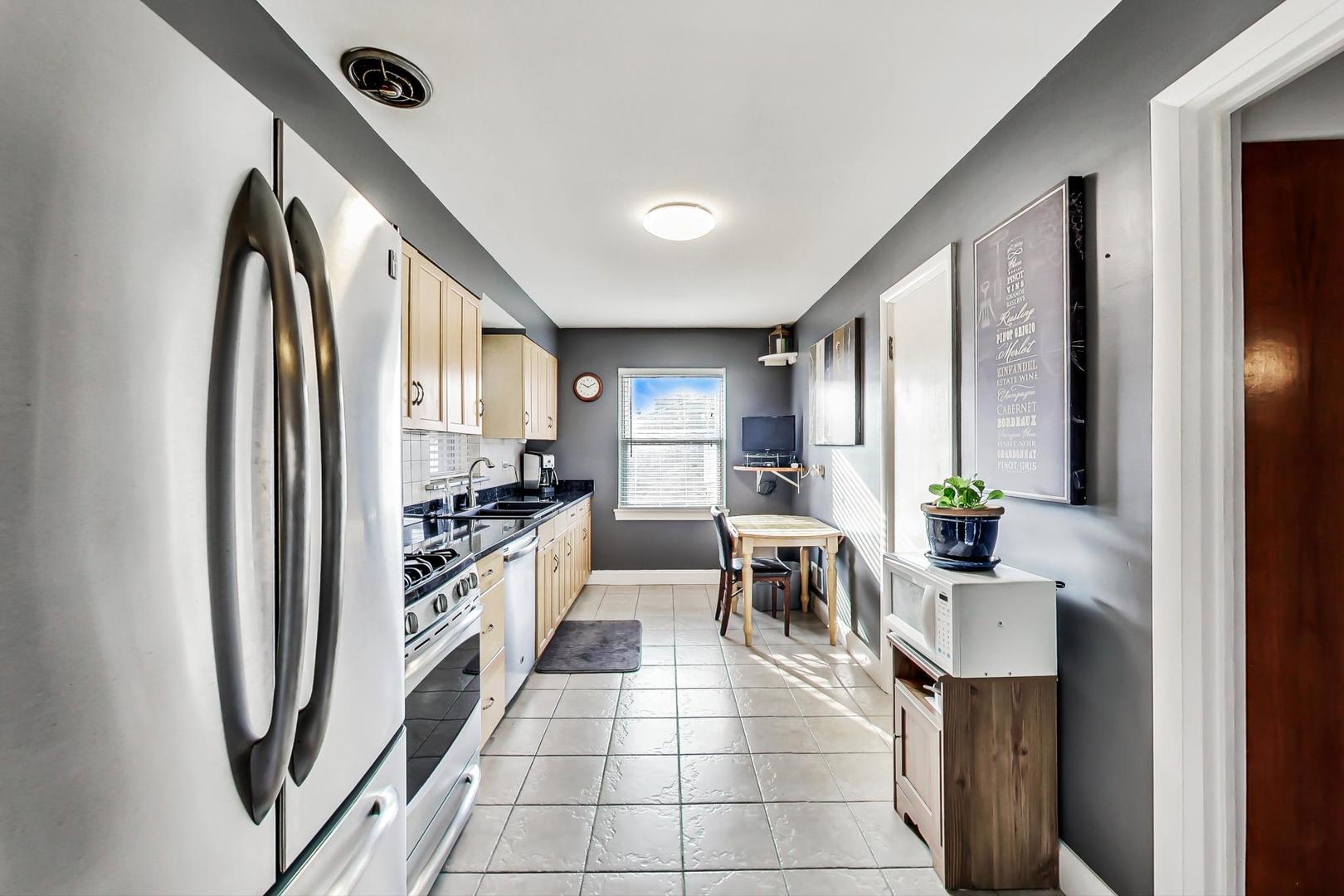 2717 West Rascher Avenue Chicago, IL 60625 - Photo 6 of 37 a kitchen with stainless steel appliances granite countertop a refrigerator and a sink