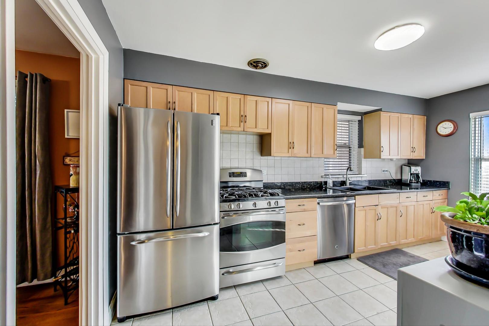 2717 West Rascher Avenue Chicago, IL 60625 - Photo 7 of 37 a kitchen with stainless steel appliances a refrigerator sink and cabinets