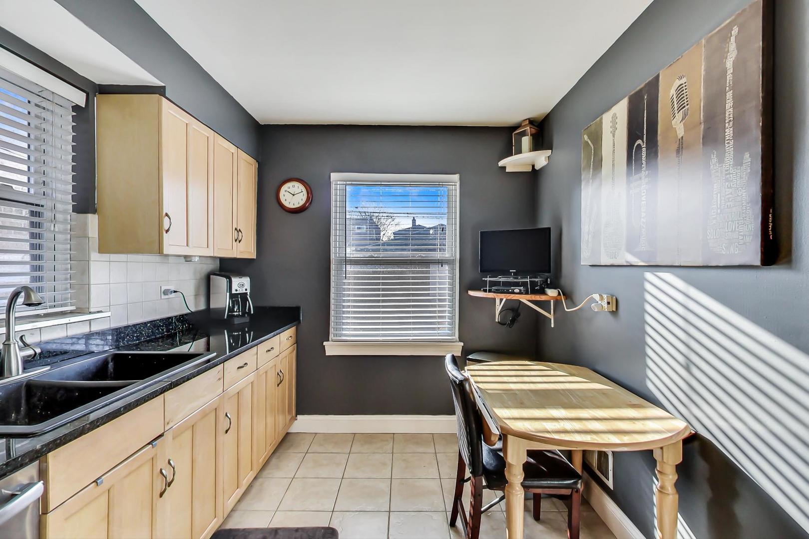2717 West Rascher Avenue Chicago, IL 60625 - Photo 8 of 37 a kitchen with a chair and appliances