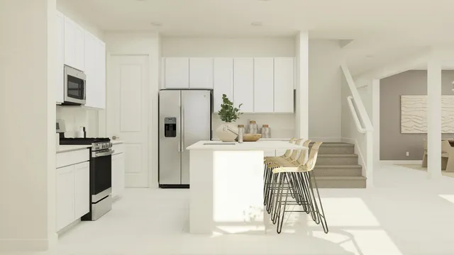 a kitchen with a refrigerator a stove and white cabinets