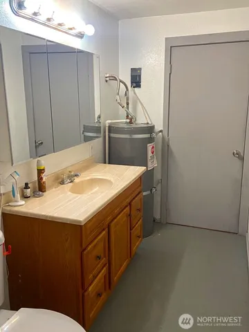 a bathroom with a sink a toilet and mirror
