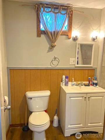 a bathroom with a toilet sink and mirror
