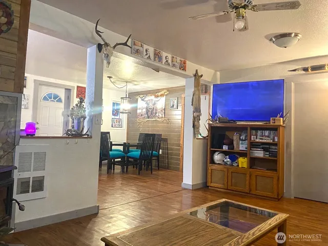 a living room with stainless steel appliances kitchen island granite countertop furniture and a kitchen view