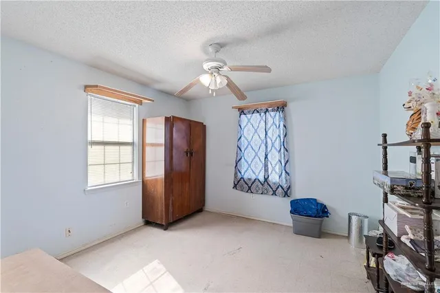 a view of an empty room with a window and closet