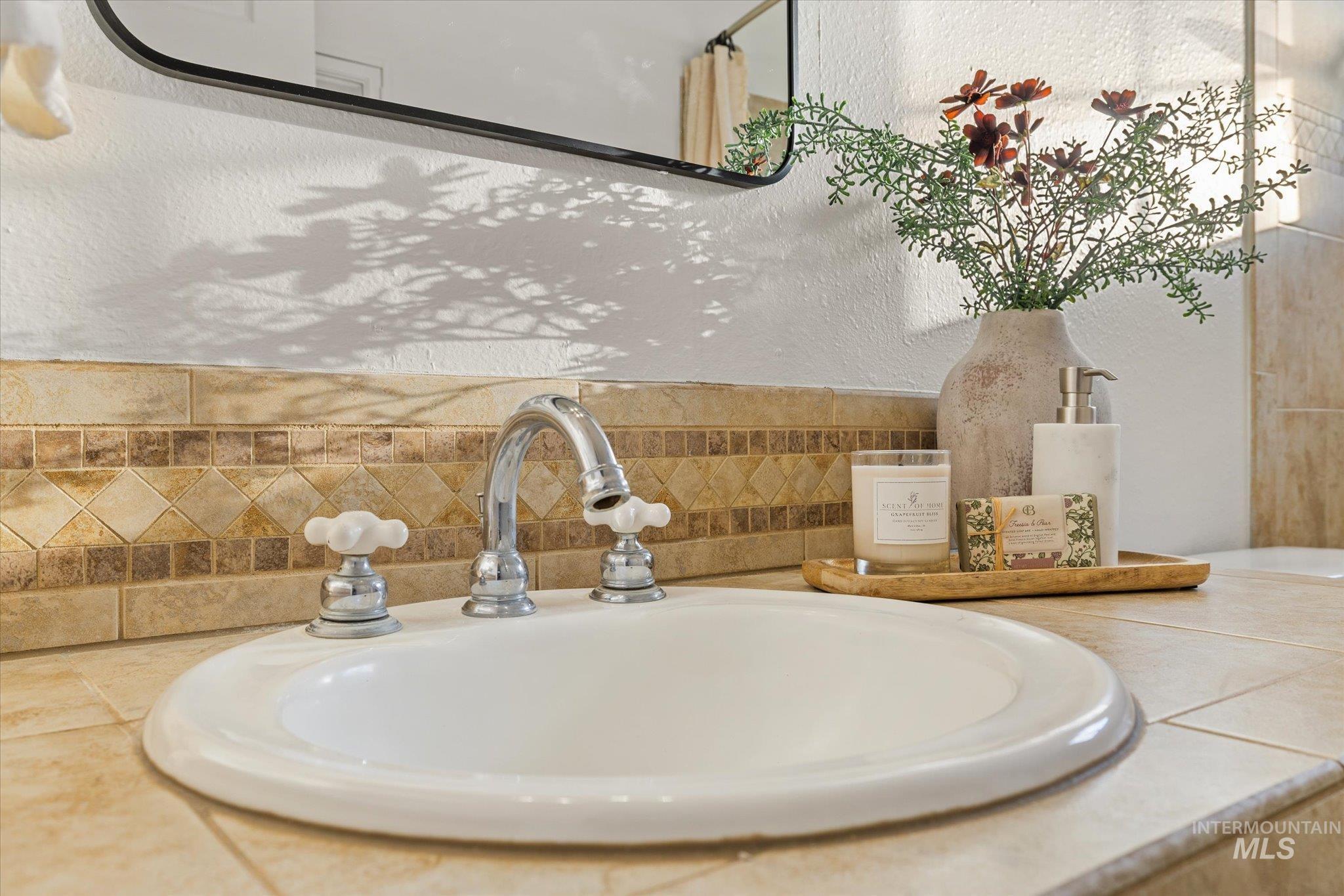 2302 Pendleton Street Boise, ID 83705 - Photo 24 of 35 White drop-in sink with a chrome three-piece faucet set featuring ceramic cross handles