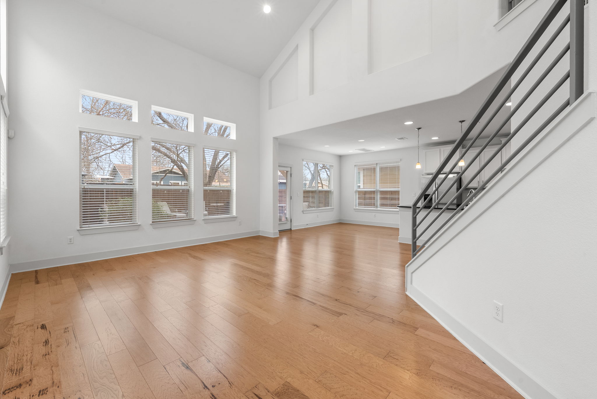 1501 Homespun Road Austin, TX 78745 - Photo 13 of 33 Unfurnished living room featuring light wood-style flooring, recessed lighting, and lofted ceiling