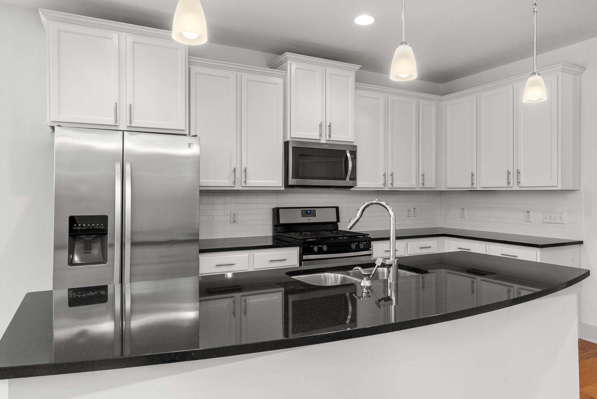 1501 Homespun Road Austin, TX 78745 - Photo 14 of 33 Kitchen featuring stainless steel appliances, white cabinetry, and dark stone counters