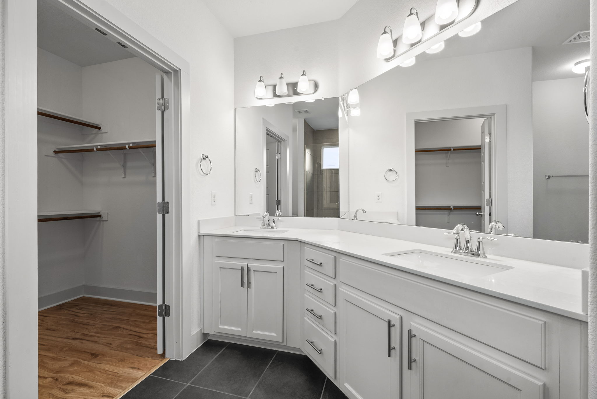 1501 Homespun Road Austin, TX 78745 - Photo 25 of 33 Full bathroom featuring a spacious closet, double vanity, and dark tile patterned floors