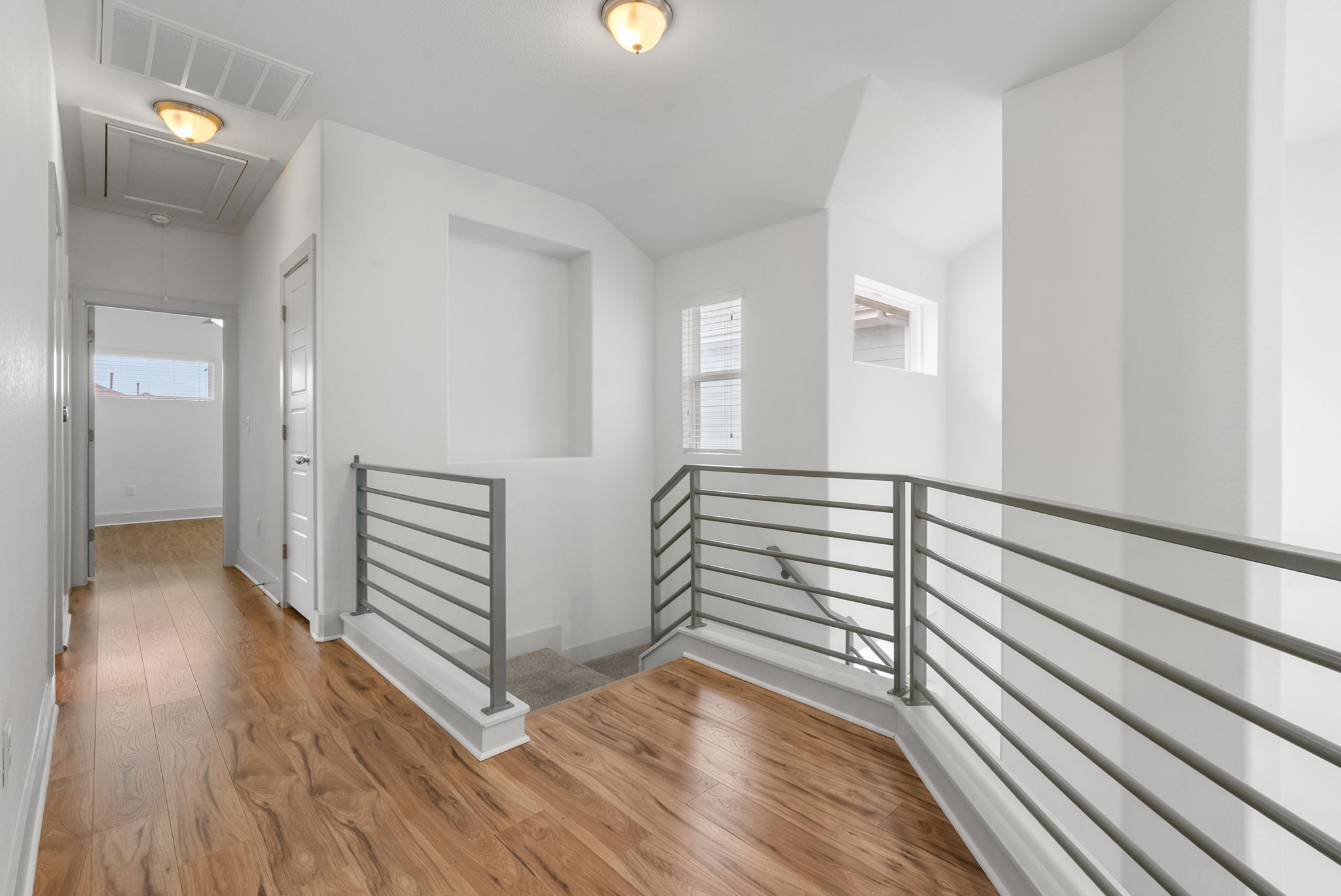 1501 Homespun Road Austin, TX 78745 - Photo 27 of 33 Corridor featuring an upstairs landing, light wood finished floors, and healthy amount of natural light
