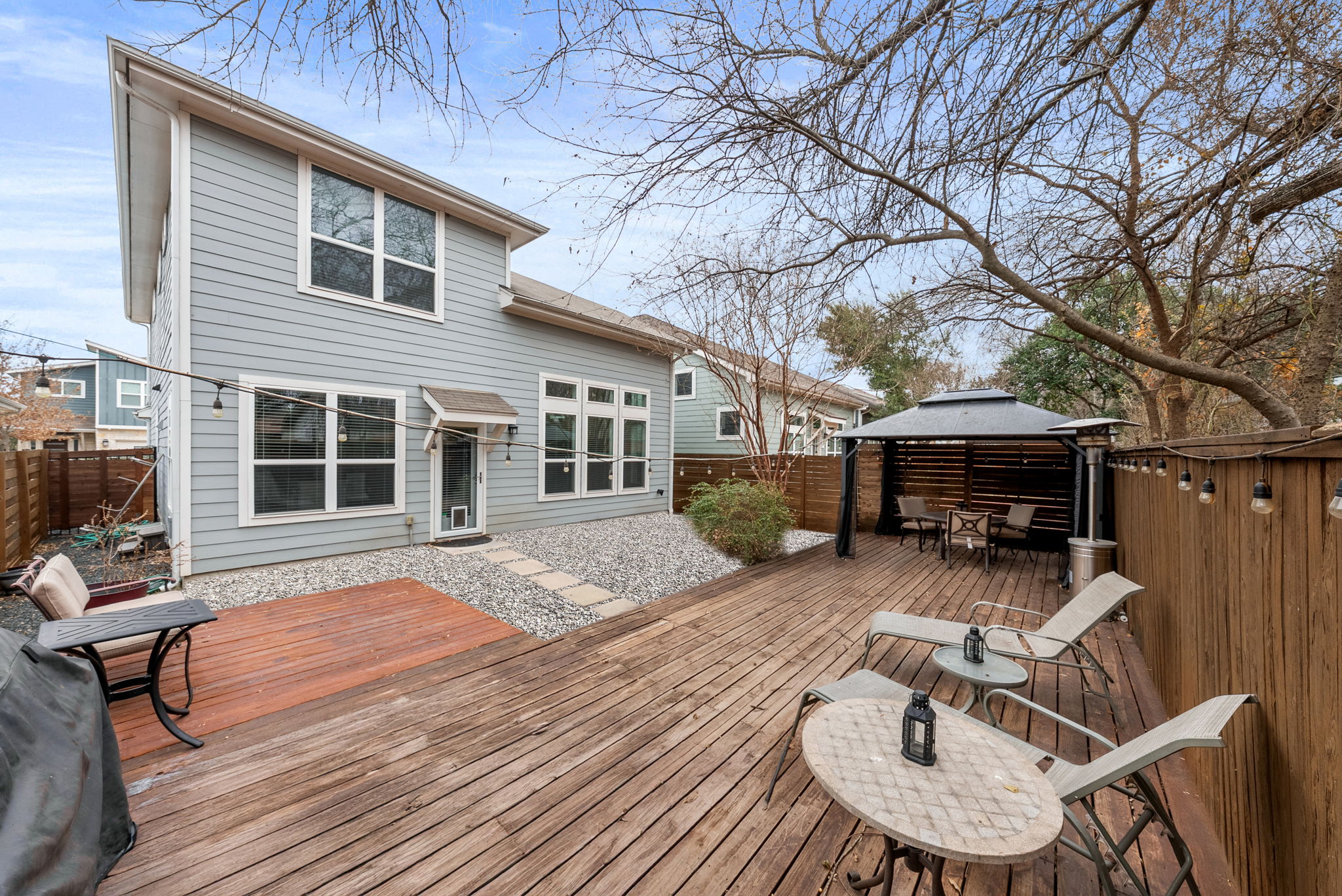 1501 Homespun Road Austin, TX 78745 - Photo 31 of 33 Wooden deck with a gazebo, outdoor dining area, and a fenced backyard