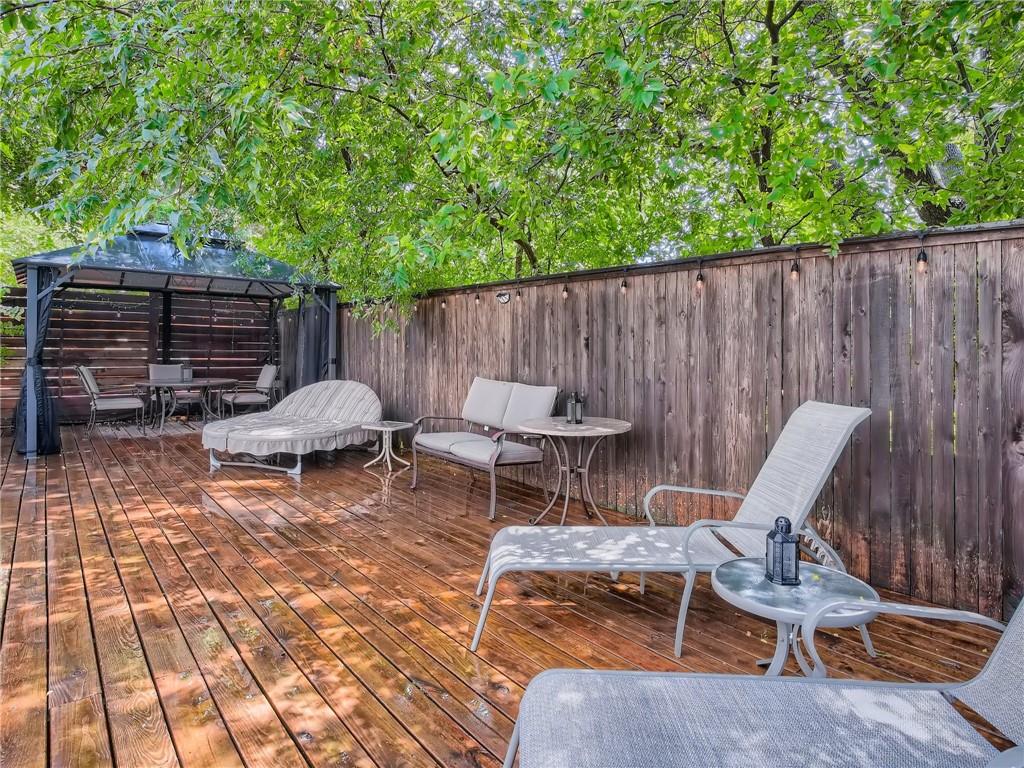 1501 Homespun Road Austin, TX 78745 - Photo 32 of 33 Wooden terrace with a fenced backyard, a gazebo, and outdoor dining space