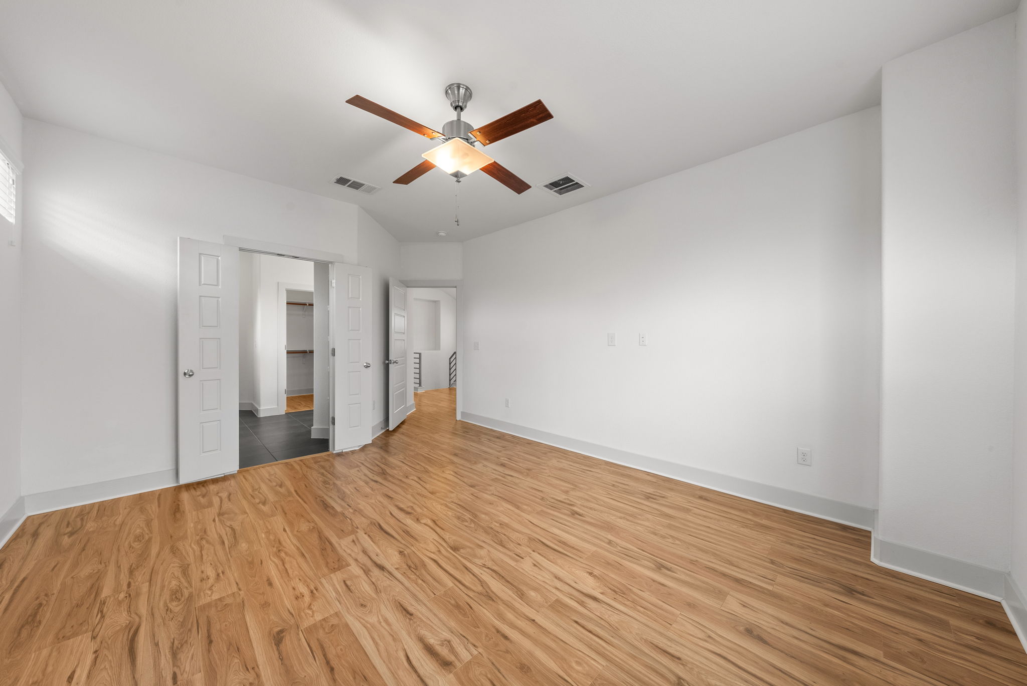 1501 Homespun Road Austin, TX 78745 - Photo 5 of 33 Unfurnished bedroom with light wood finished floors and a ceiling fan